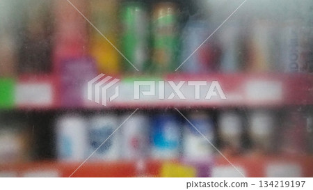 Blurry photo of bottled drinks on supermarket shelves 134219197