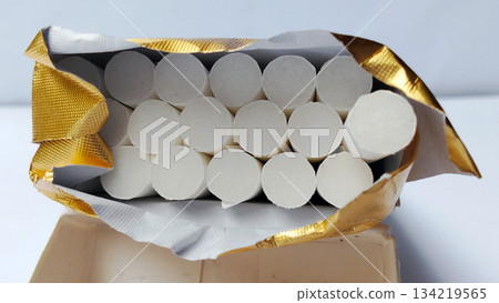 Close-up image of cigarettes in an open pack. Close-up image of cigarettes in an open pack. 134219565