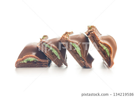 Chocolate bar with pistachios cream isolated on white background. Chocolate bar with pistachios cream isolated on white background. 134219586