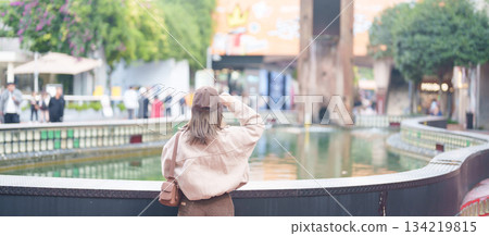 Happy woman traveler travel in Chengdu city. Tourist sightseeing and shopping in Eastern Suburb Memory or Dongjiao Ji Yi. Famous Landmark for tourism attraction in Sichuan, China 134219815