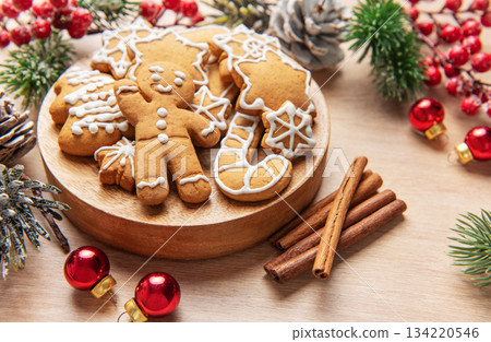 Gingerbread cookies on wooden plate with christmas decor Gingerbread cookies on wooden plate with christmas decor 134220546