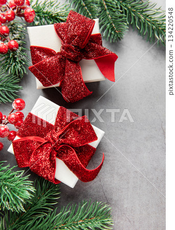 Christmas gifts with red glitter bows on grey background Christmas gifts with red glitter bows on grey background 134220548