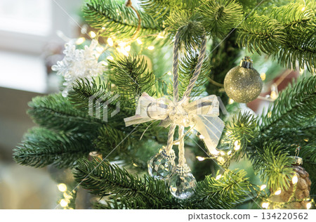 Christmas tree decorating with festive silver and crystal ornaments Christmas tree decorating with festive silver and crystal ornaments 134220562