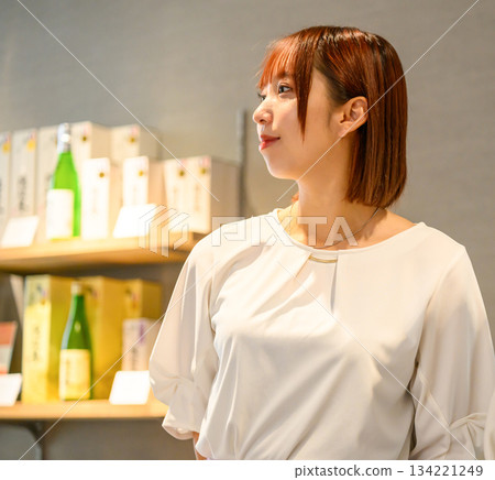 A woman browsing products at a souvenir shop 134221249