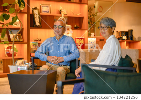 Mature couple relaxing in a hotel lounge Mature couple relaxing in a hotel lounge 134221256