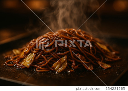 Steaming yakisoba noodles with sauce on a hot plate 134221265