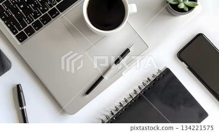 A well-equipped workspace with a laptop and coffee 134221575