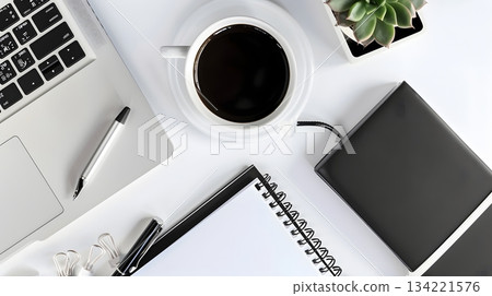 A well-equipped workspace with a laptop and coffee 134221576