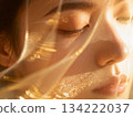 Close-up of a woman's face with closed eyes and a glittering veil 134222037
