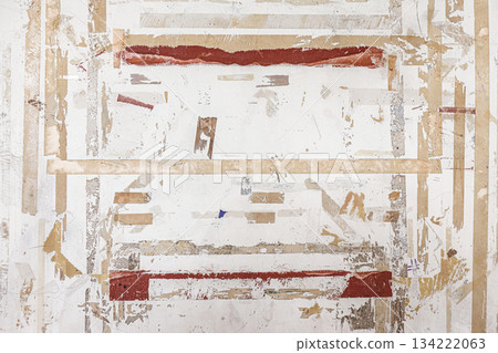 Grunge texture of a concrete wall with remnants of adhesive tape 134222063