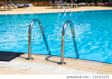 Handrails of the iron staircase to the pool 134222255