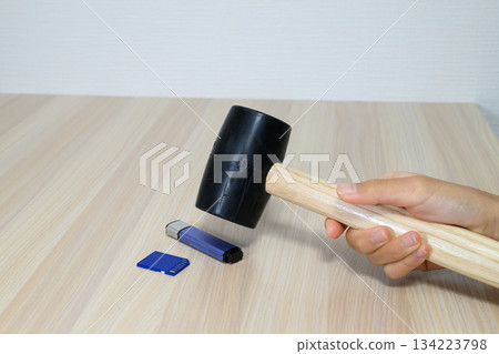 Recording media being crushed with a hammer 134223798