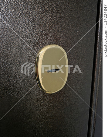 Close up of brass keyhole on dark door 134224847