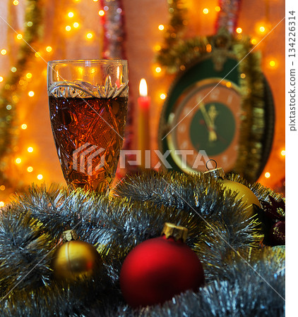 Glass of wine on the background of the clock with the lack of focus Glass of wine on the background of the clock with the lack of focus 134226314