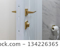 Modern White Door with Golden Handle in Bathroom Interior 134226365