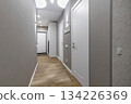Modern Hallway with White Doors and Wooden Floor in Apartment Interior 134226369