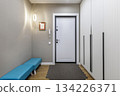 Bright Hallway with White Entrance Door and Blue Bench in Modern Apartment 134226371