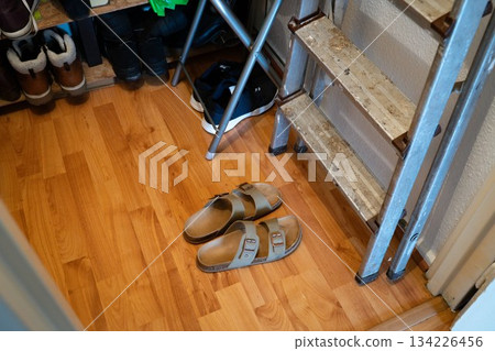 Beige sliders in wardrobe space with step ladder 134226456