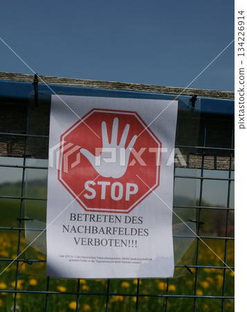 Sign with a red octagon and a hand on it that says Stop 134226914