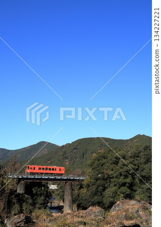 Nagaragawa Railway running along the Nagara River in autumn Nagaragawa Railway running along the Nagara River in autumn 134227221