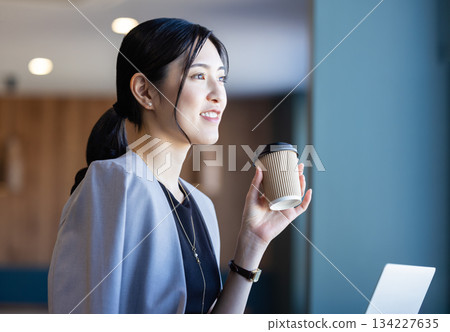 Coffee drinking business woman Coffee drinking business woman 134227635