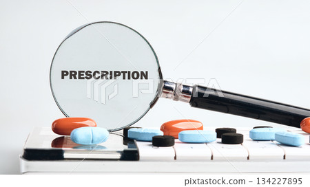 A clear magnifying glass is focused on the word prescription while colorful tablets rest on a white surface, highlighting the significance of careful medication management in health A clear magnifying glass is focused on the word prescription while colorful tablets rest on a white surface, highlighting the significance of careful medication management in health 134227895