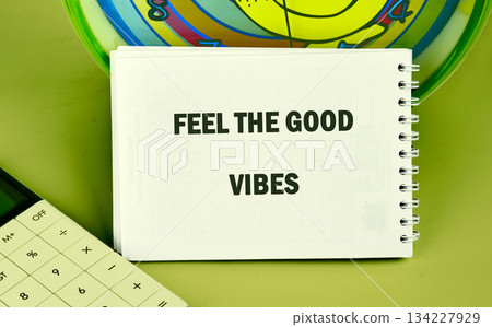 A workspace brimming with positivity features a notebook displaying an uplifting phrase. The cheerful atmosphere encourages creativity and good vibes during productive hours 134227929