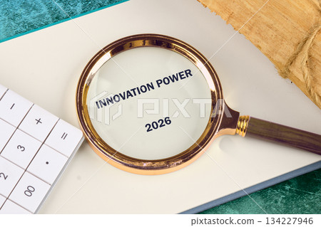 A magnifying glass highlights the words Innovation Power, showcasing future goals for 2026 134227946