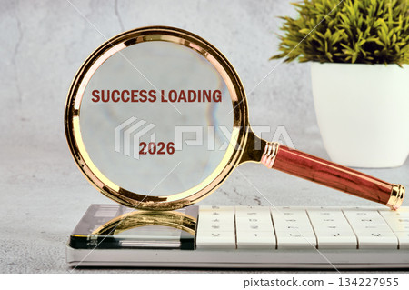 A magnifying glass highlights the phrase success loading as it rests on a modern calendar, symbolizing hope and anticipation for achievements in the year 2026 A magnifying glass highlights the phrase success loading as it rests on a modern calendar, symbolizing hope and anticipation for achievements in the year 2026 134227955