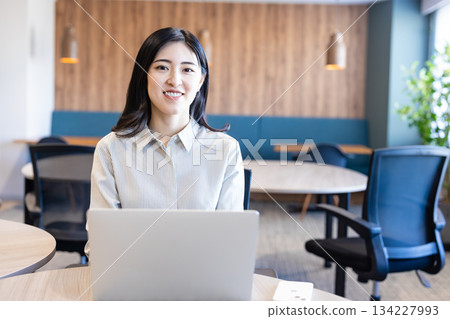 A woman working with a laptop A woman working with a laptop 134227993