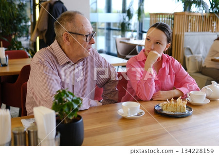 Grandfather and granddaughter went to a restaurant, meeting grandfather, grandmother and a teenage girl, walking together, socializing Grandfather and granddaughter went to a restaurant, meeting grandfather, grandmother and a teenage girl, walking together, socializing 134228159