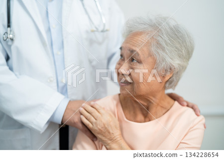 Caregiver holding hands Asian elderly woman patient with love, care, encourage and empathy at nursing hospital, healthy strong medical. 134228654