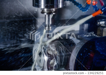 CNC milling machine cutting the mold parts with oil coolant method The mold and die manufacturing process by machining center with the solid ball endmill tools. 134229251