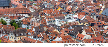 Scenic aerial view patchwork of Heidelberg red rooftops tiled roofs historical colorful houses medieval old city German Baden-Wurttemberg. Abstract texture charm historic old town architecture Scenic aerial view patchwork of Heidelberg red rooftops tiled roofs historical colorful houses medieval old city German Baden-Wurttemberg. Abstract texture charm historic old town architecture 134229265