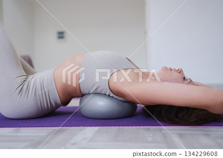 Pilates back stretch exercise ball workout woman training spine flexibility Pilates back stretch exercise ball workout woman training spine flexibility 134229608
