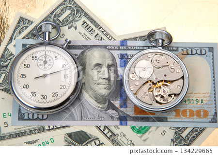 mechanical stopwatch on the background of dollars. Part time accuracy for business. mechanical stopwatch on the background of dollars. Part time accuracy for business. 134229665