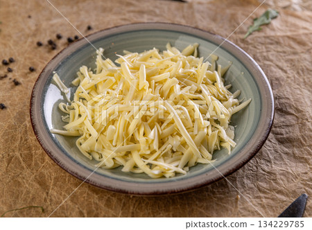 Shredded cheese filling a plate 134229785