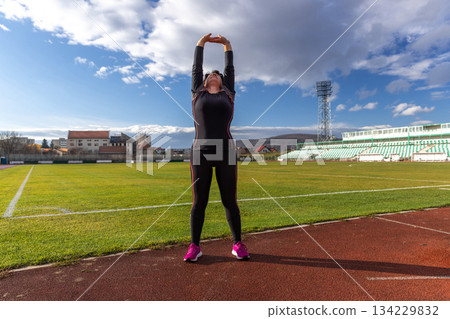 Woman stretching arms Woman stretching arms 134229832