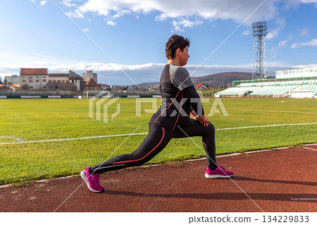 Woman stretching in lunge Woman stretching in lunge 134229833