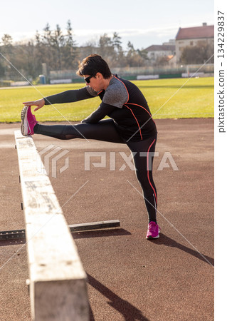 Athlete woman stretching leg Athlete woman stretching leg 134229837