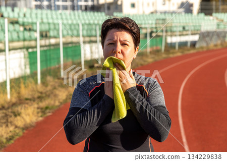 Woman drying face with a towel Woman drying face with a towel 134229838