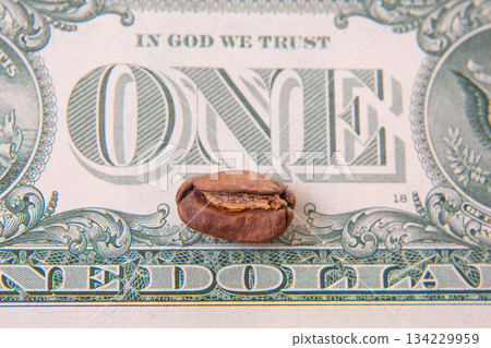 Close-up of a split coffee bean on a one-dollar bill, merging the rustic charm of agriculture  134229959