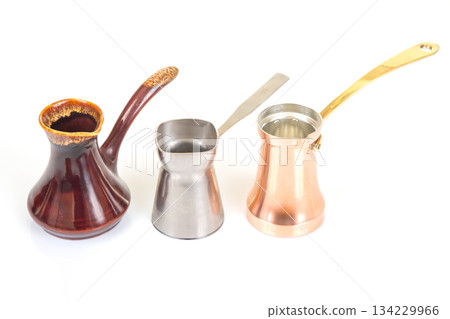 A set of three Turkish coffee pots in stainless steel, glazed ceramic 134229966