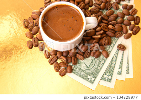 striking image of a Turkish coffee cup with coffee beans and U.S. one-dollar bills striking image of a Turkish coffee cup with coffee beans and U.S. one-dollar bills 134229977