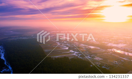 Spring rural landscape. Countryside in the evening. Aerial view. Panoramic view of village, fields, pine forest, and river during sunset 134231337