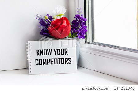 KNOW YOUR COMPETITORS text on paper on a window background KNOW YOUR COMPETITORS text on paper on a window background 134231346