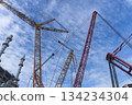 Crane is seen in the sky above a large industrial plant 134234304