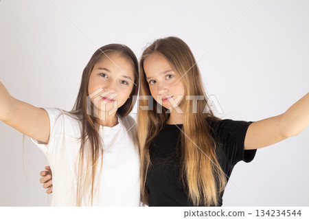 Two teenage girls taking a selfie, capturing a happy, fun moment together 134234544