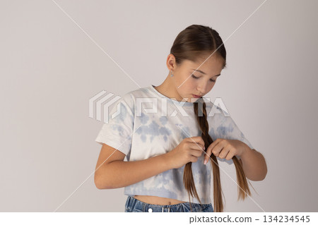 Young woman looking into her purse or small bag, focused expression 134234545