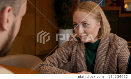 Young woman smiling and talking, actively engaged in a discussion 134234612